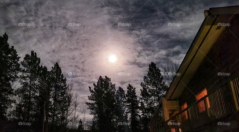 Full moon beaming through the clouds