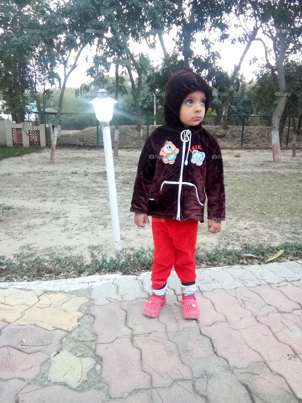 a cute little boy in a park.