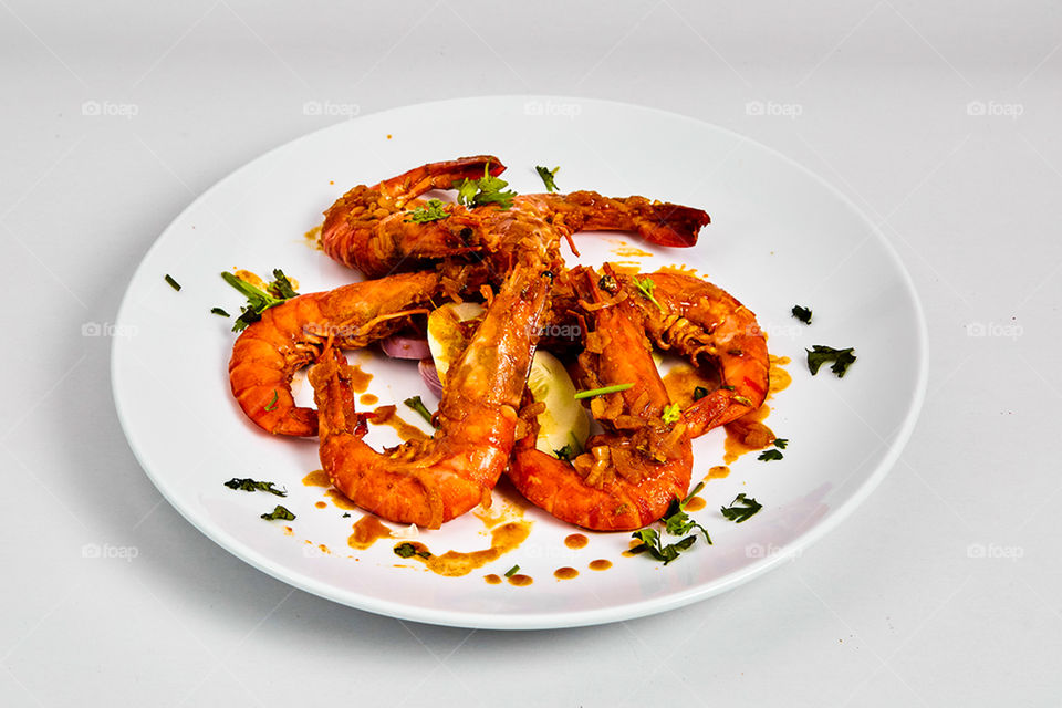 fried shrimp on a white plate.