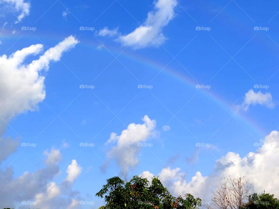 beautiful rainbow on sky nice 3 colour show on sky also nice white clouds