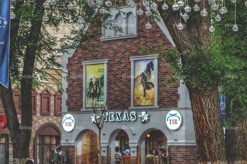 cafe in the style of the wild west with beautiful brickwork and Texas lettering. Authentic wild west saloon.