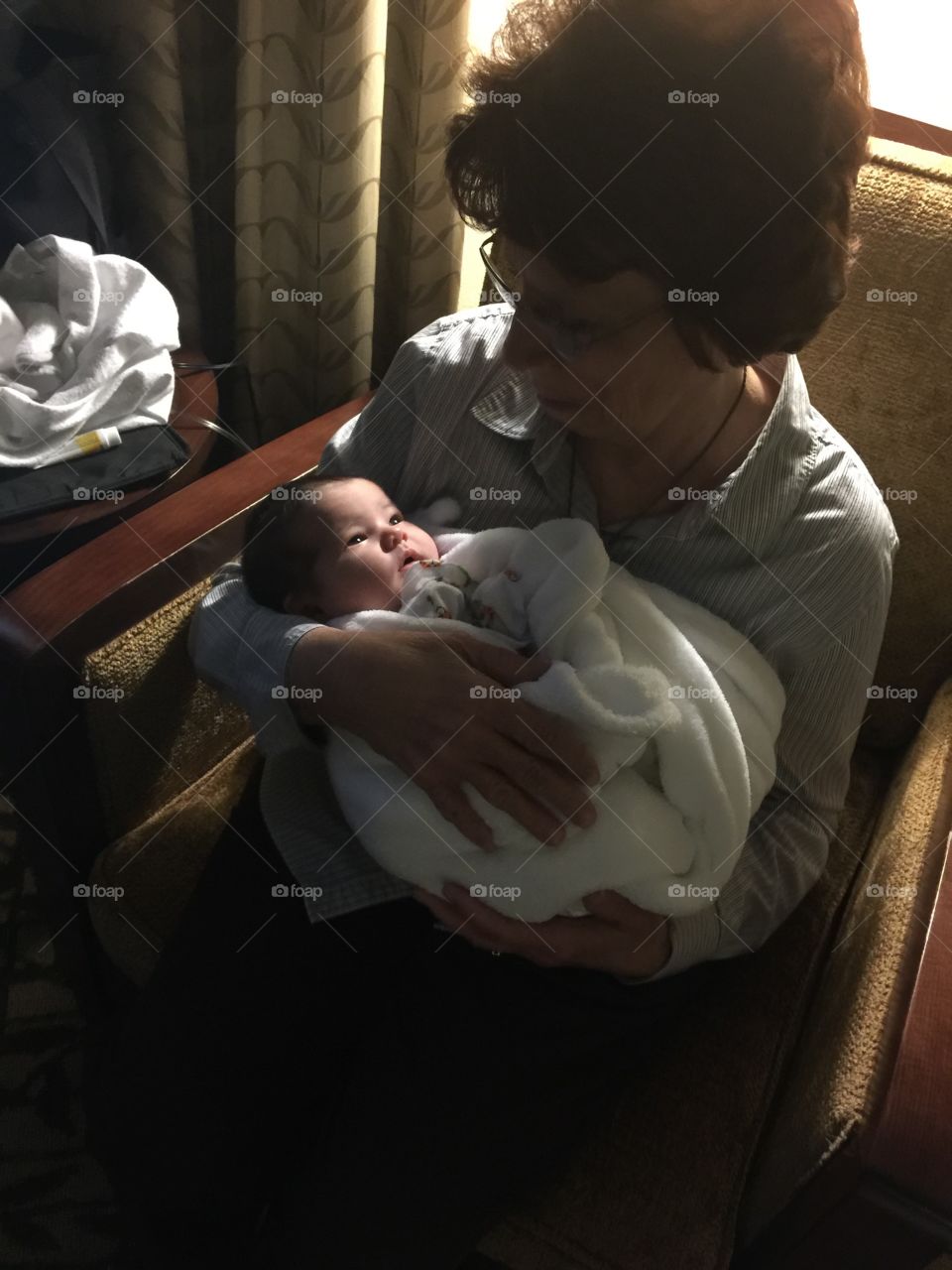 Grandma meets newborn. Baby meets grandma