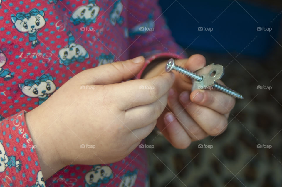 little girl holding tools