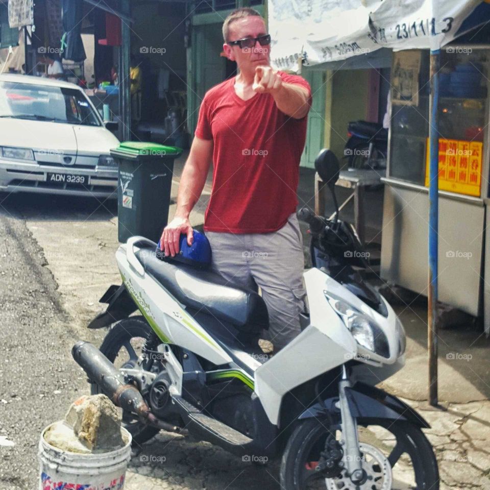 posing with scooter in Indonesia