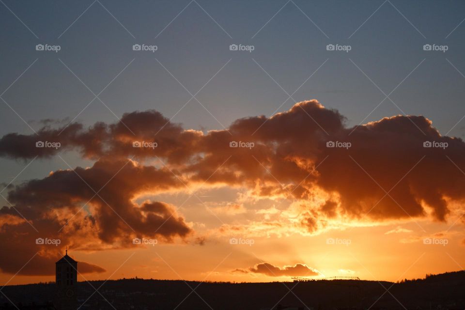 Sunset with sunrays illuminating the clouds.