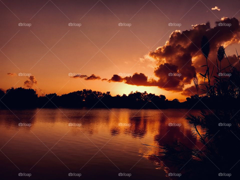 As the Evening sky takes shape, the colors appear in the Western sky. Invincible clouds take shape to form an eventful Sunset setting. 