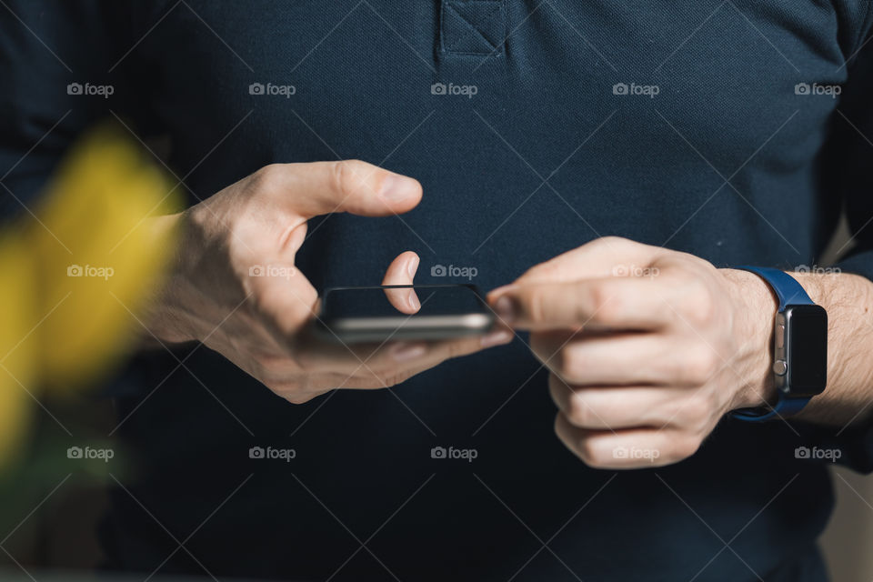 the man uses a mobile phone