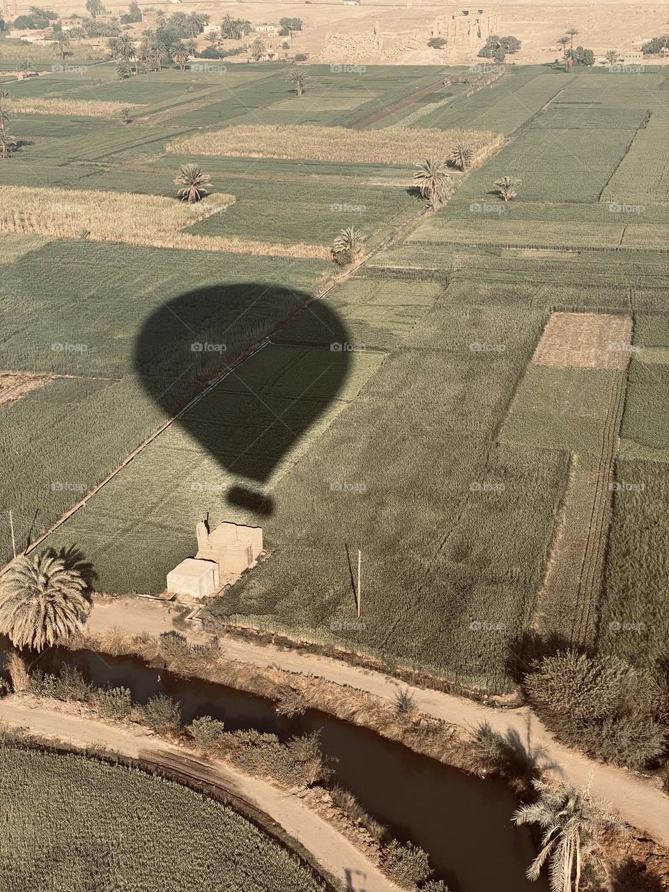 The shadow of hot air balloon from another one 
