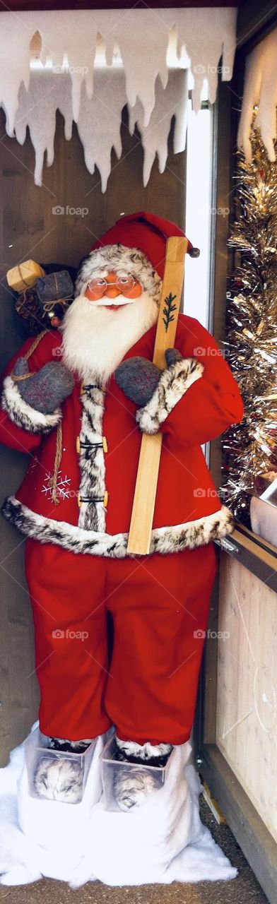 Santa Claus puppet next to a Christmas market stand in Montreux, Switzerland 