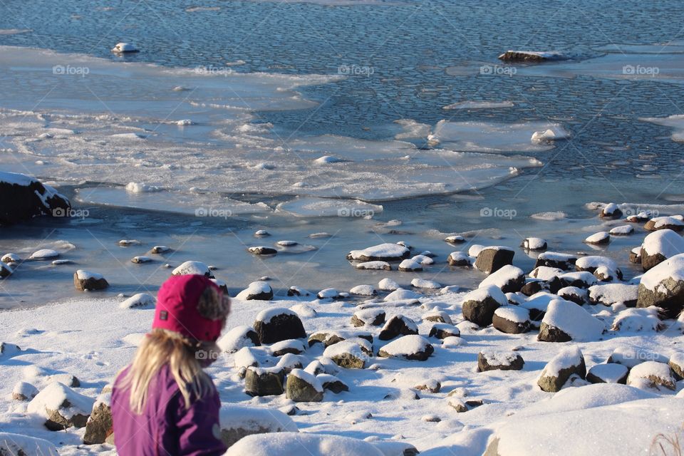 A girl by the icy sea