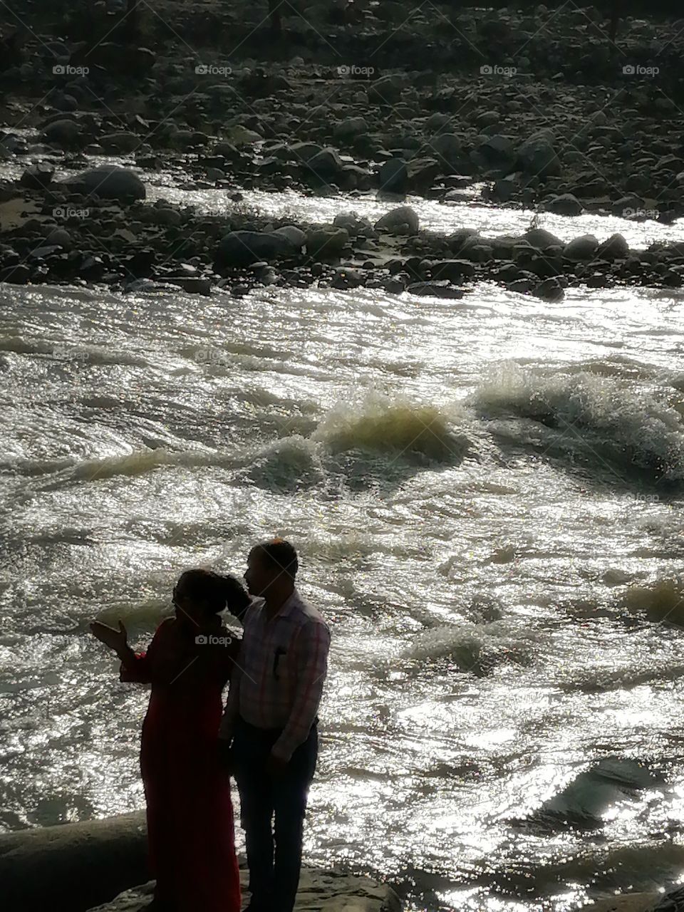 Couple or Tourist looking flow of river.