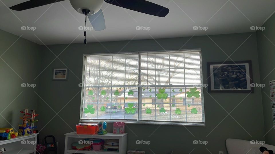 Decorating for St. Patrick’s Day, cherry clover on the front windows, decorating our home for St. Patrick’s Day, lots of clover clings on windows of house