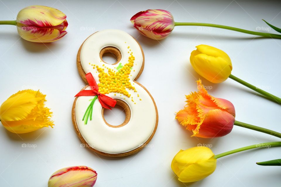 8 March gingerbread and colorful tulips on a white background women's day