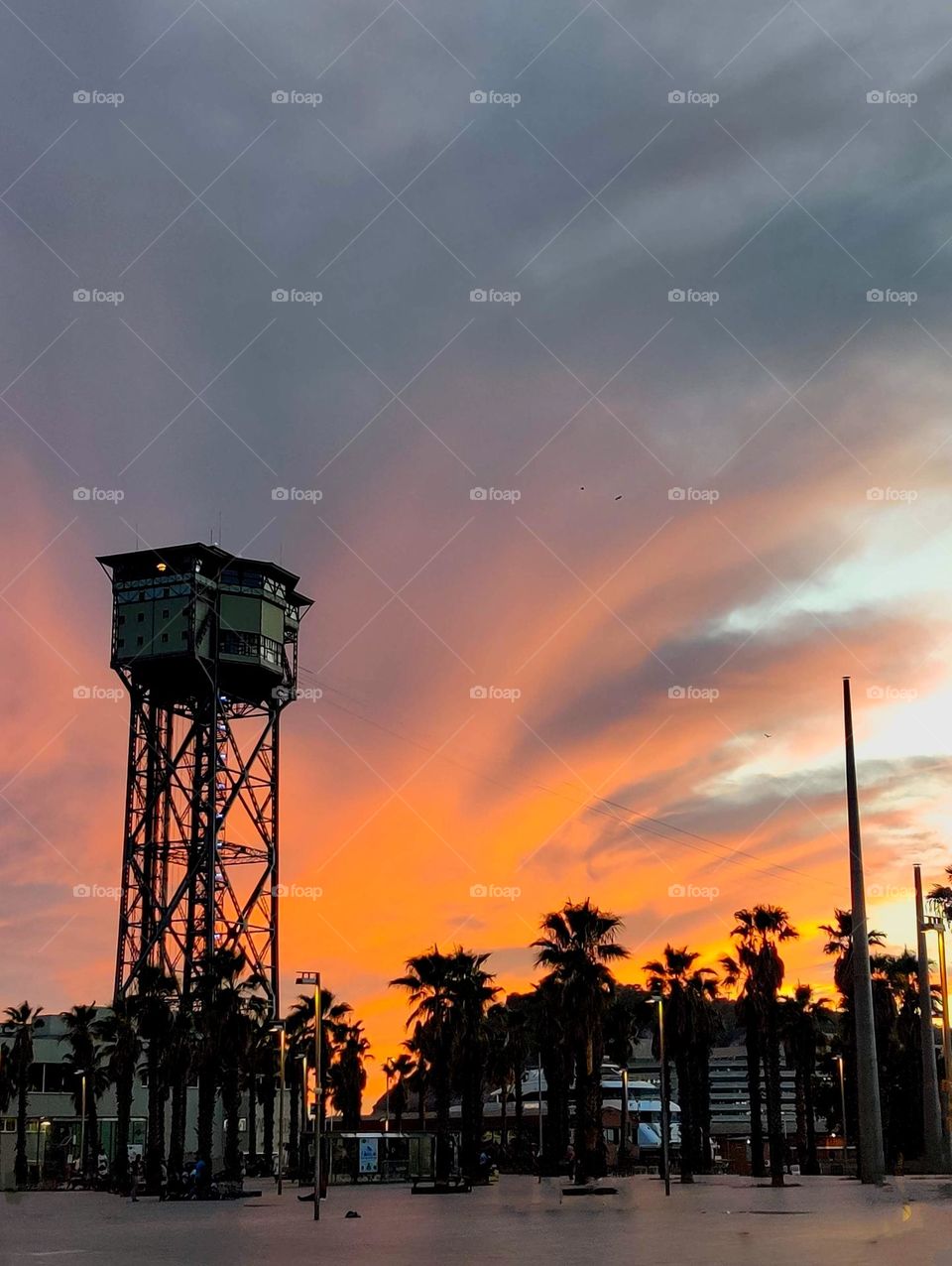 Barceloneta Beach in Barcelona, Spain. A summer sunset illuminating the sky.