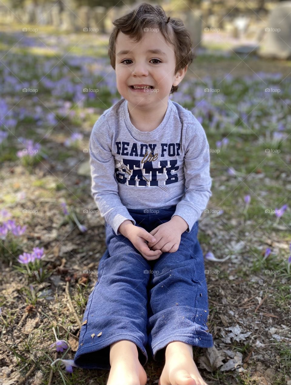 Boy sitting in flowers