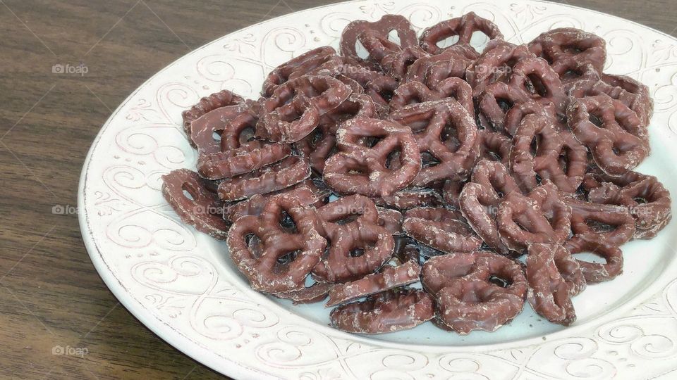 chocolate covered pretzels on a white plate