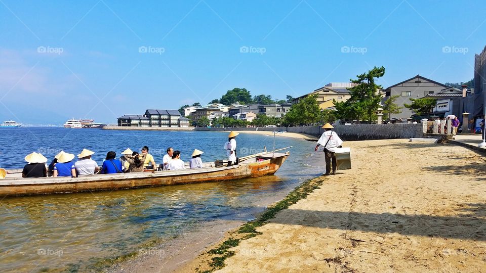 Long-tail boat with people on the beach