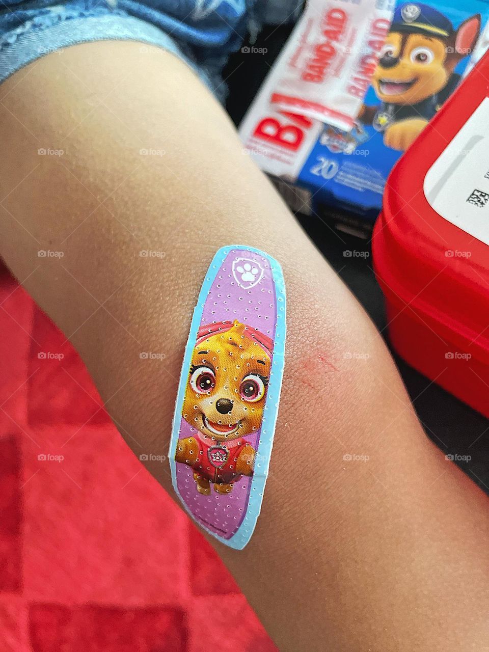 Putting a bandage on toddler’s knee, paw patrol bandage for toddler girl, band-aid for a scrape, first aid for children, fixing boo boos