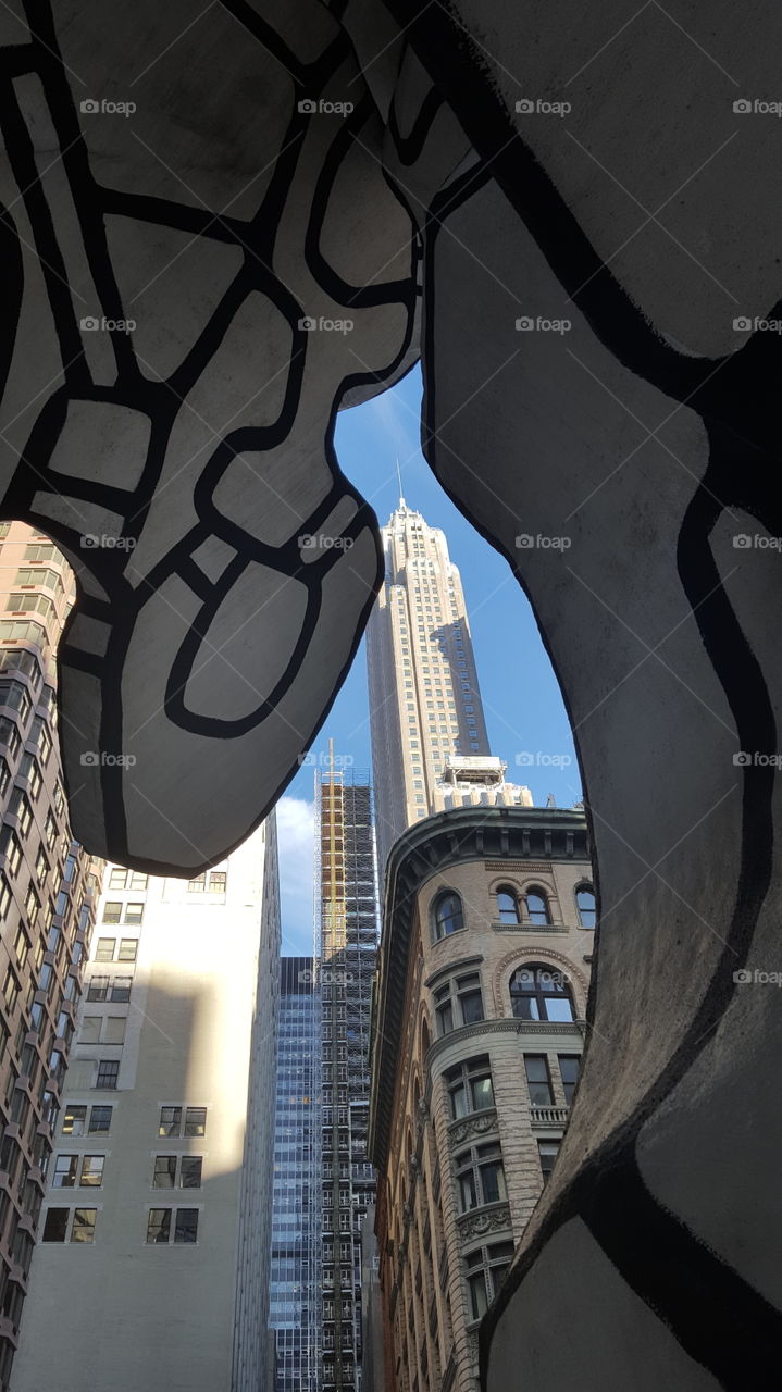 Financial District view from beneath Group of Four Trees statue