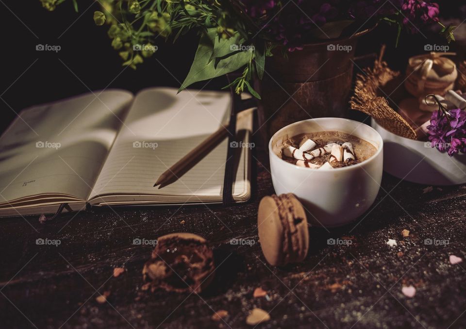 Hot chocolate with macaroons on a wood table 