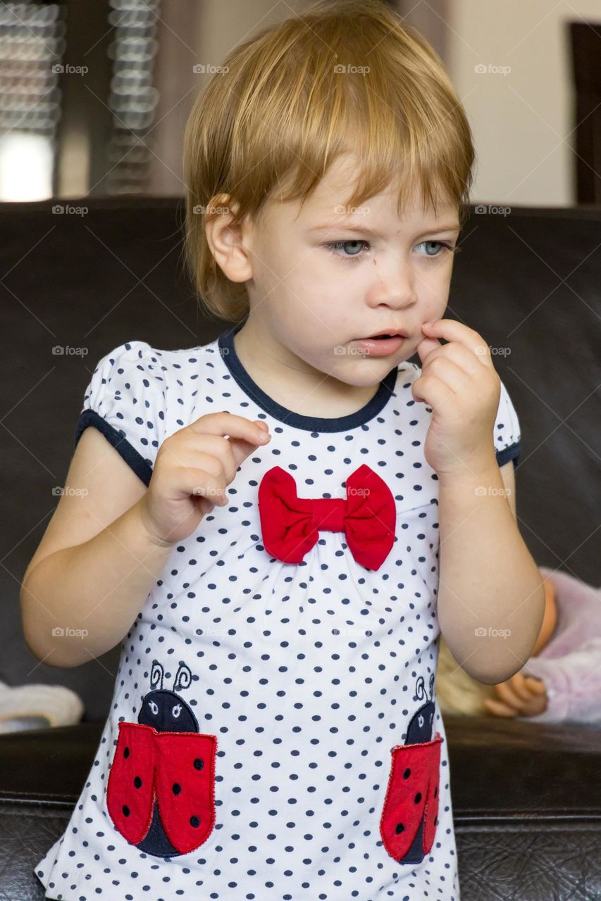 Baby girl dressed in the polka dot shirt