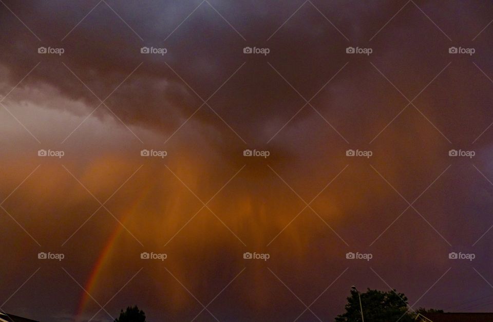 A double rainbow on the edge of a storm