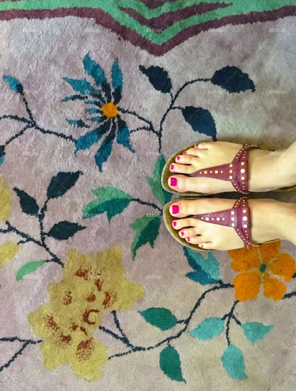 Sandals on floral rug