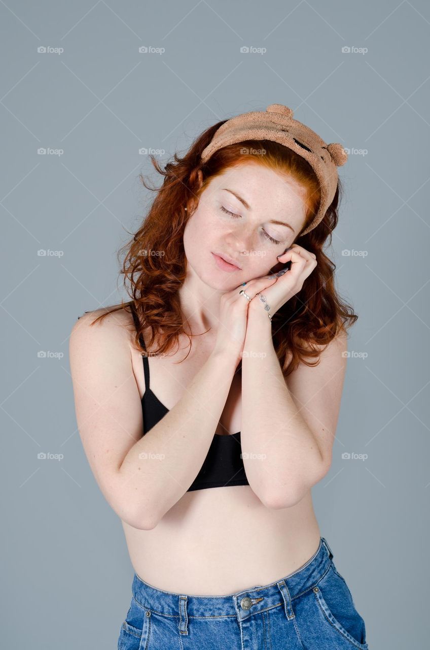 Close up portrait of beautiful young redhead woman,  girl in studio. Curly red hair. Lifestyle people