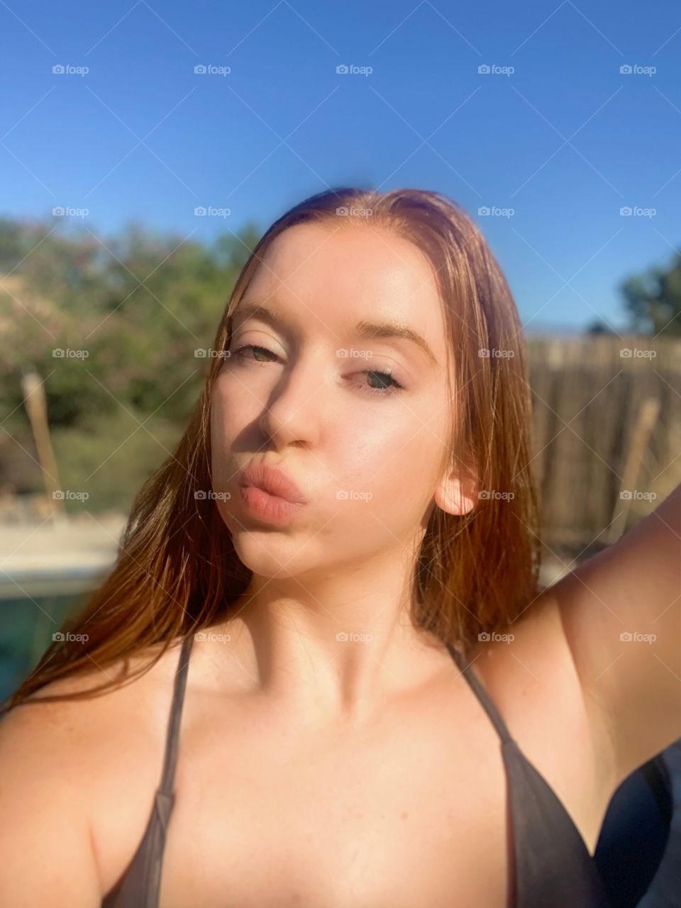 Cute photograph of a young redheaded model posing in a bikini