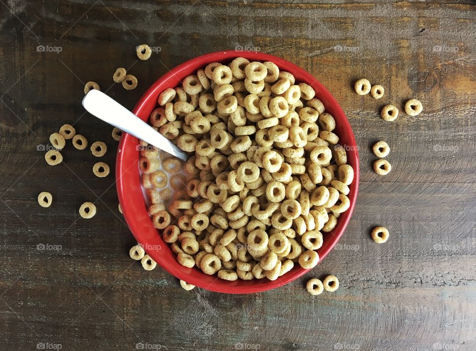 Red Bowl of Toasted Oat Cereal in Milk