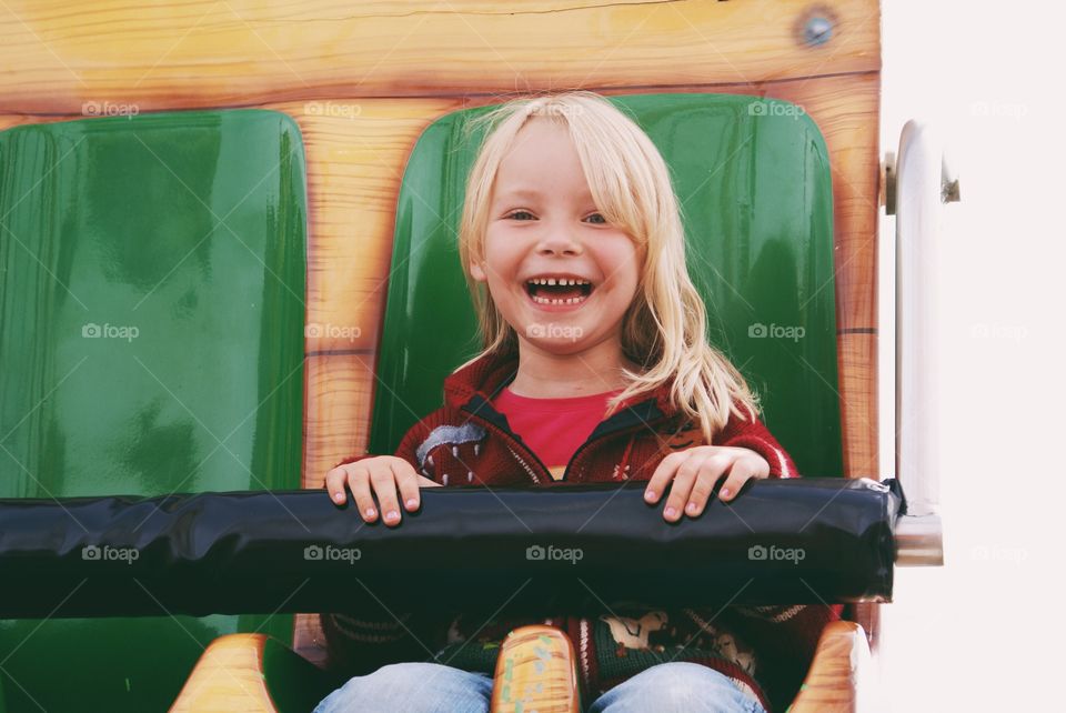 Very happy girl on the amusement ride