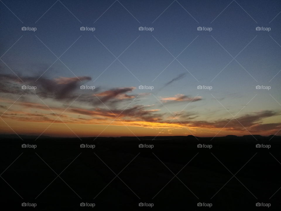 A large drop of sun lingered on the horizon and then dripped over and was gone, and the sky was brilliant over the spot where it had gone, and a torn cloud, like a bloody rag, hung over the spot of its going. And dusk crept over the sky from the eastern horizon, and darkness crept over the land from the east.
John Steinbeck, The Grapes of Wrath