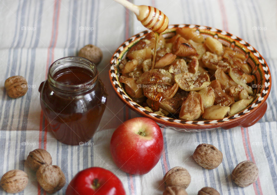 Autumn mood, home cooking. Baked apples with honey and walnuts