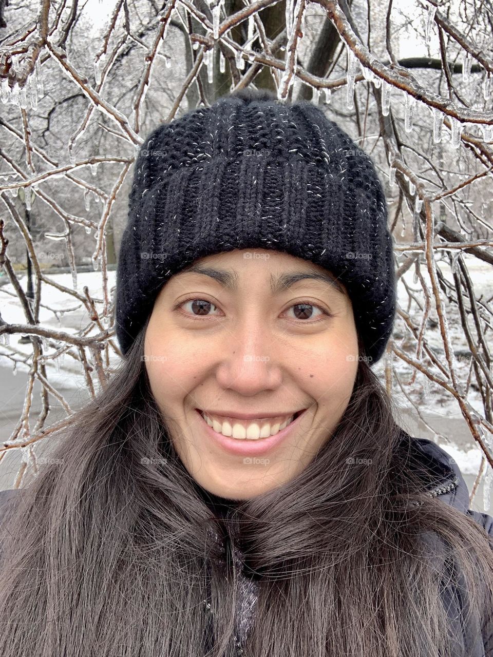 Portrait of a smiling woman with icicles background 