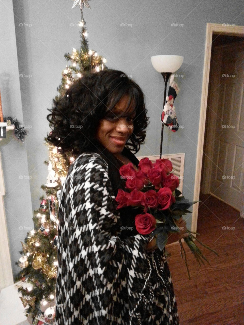 African woman holding rose flower bunch