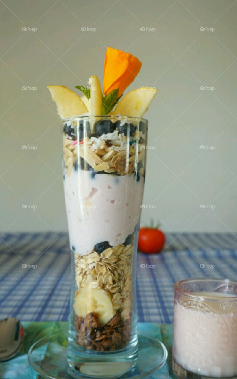 Fresh fruit smoothie - blueberry banana coconut strawberries and nuts