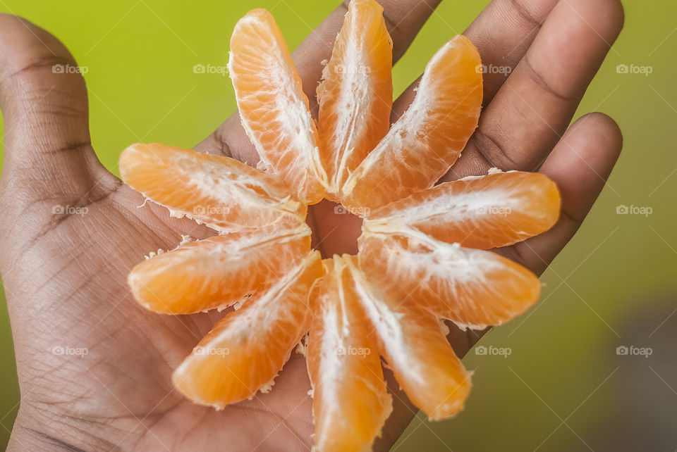 Hand holding slice orange fruits