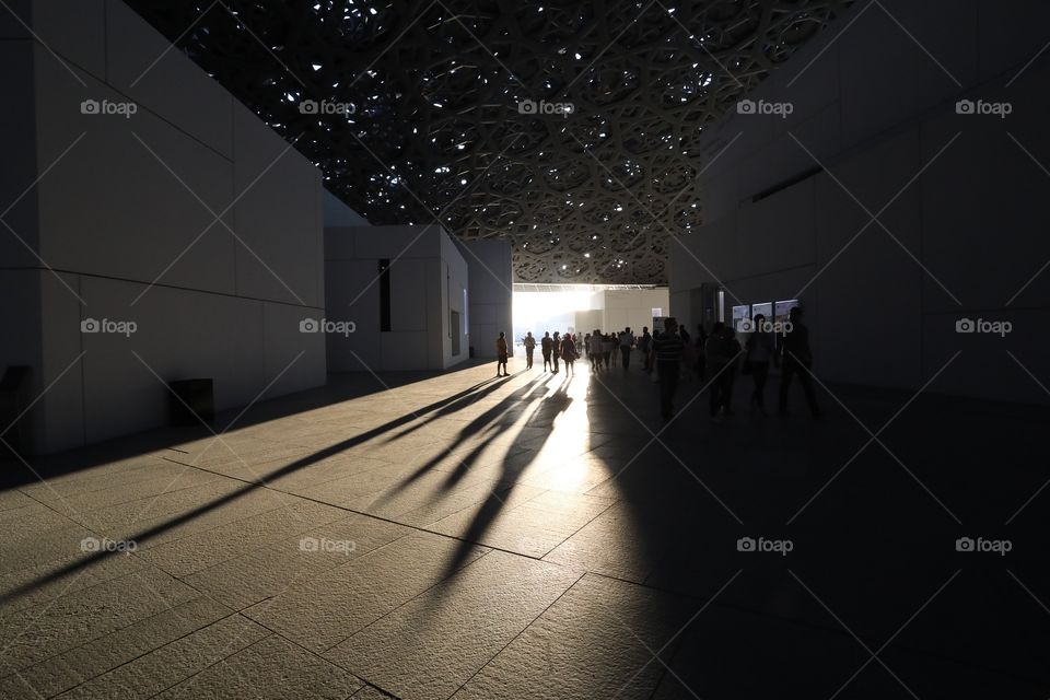Long shadows are cast at the Louvre Abu Dhabi, UAE as the sun sets.