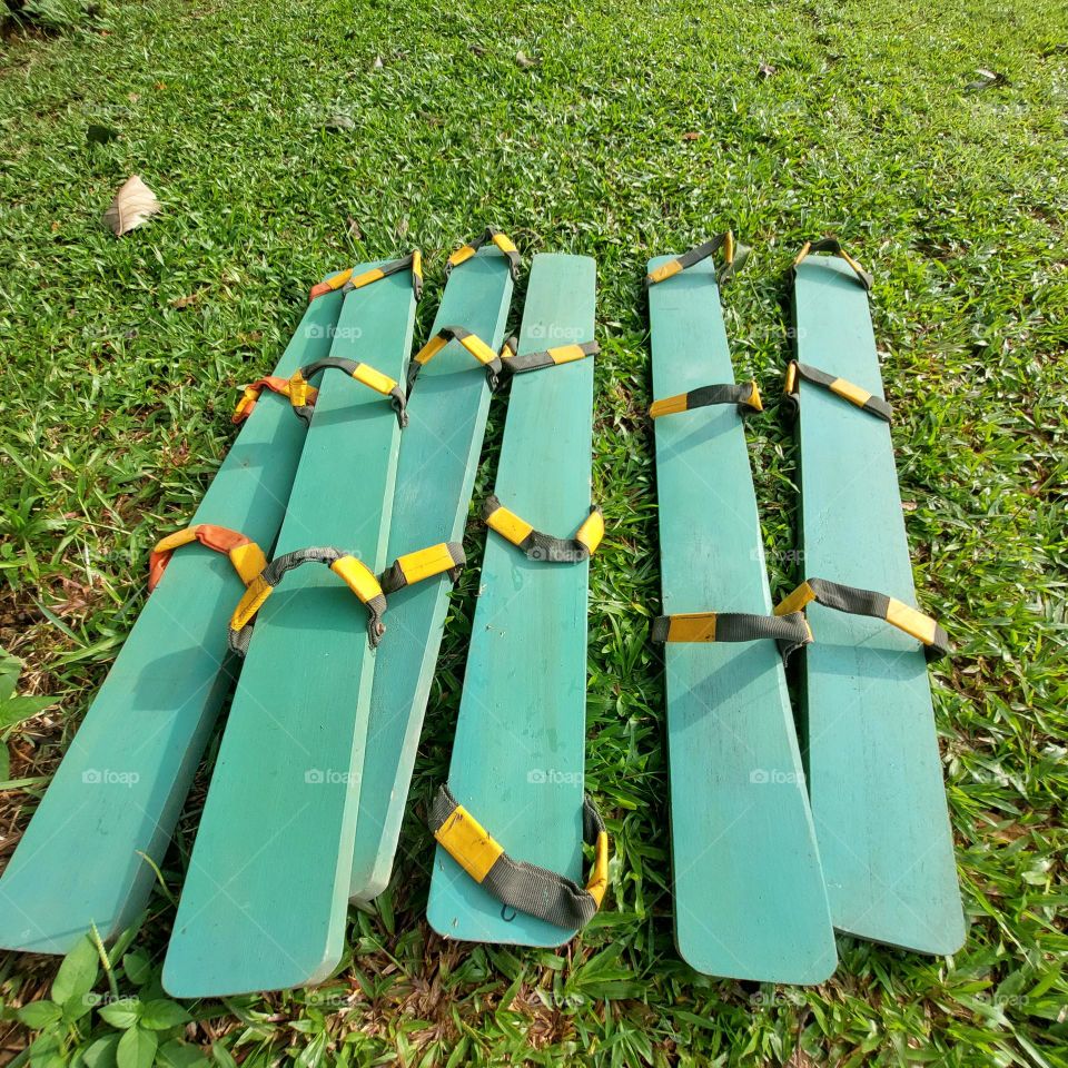 a traditional game tool from Indonesia "clogs" made of long wooden boards and rubber straps that rely on team cohesiveness