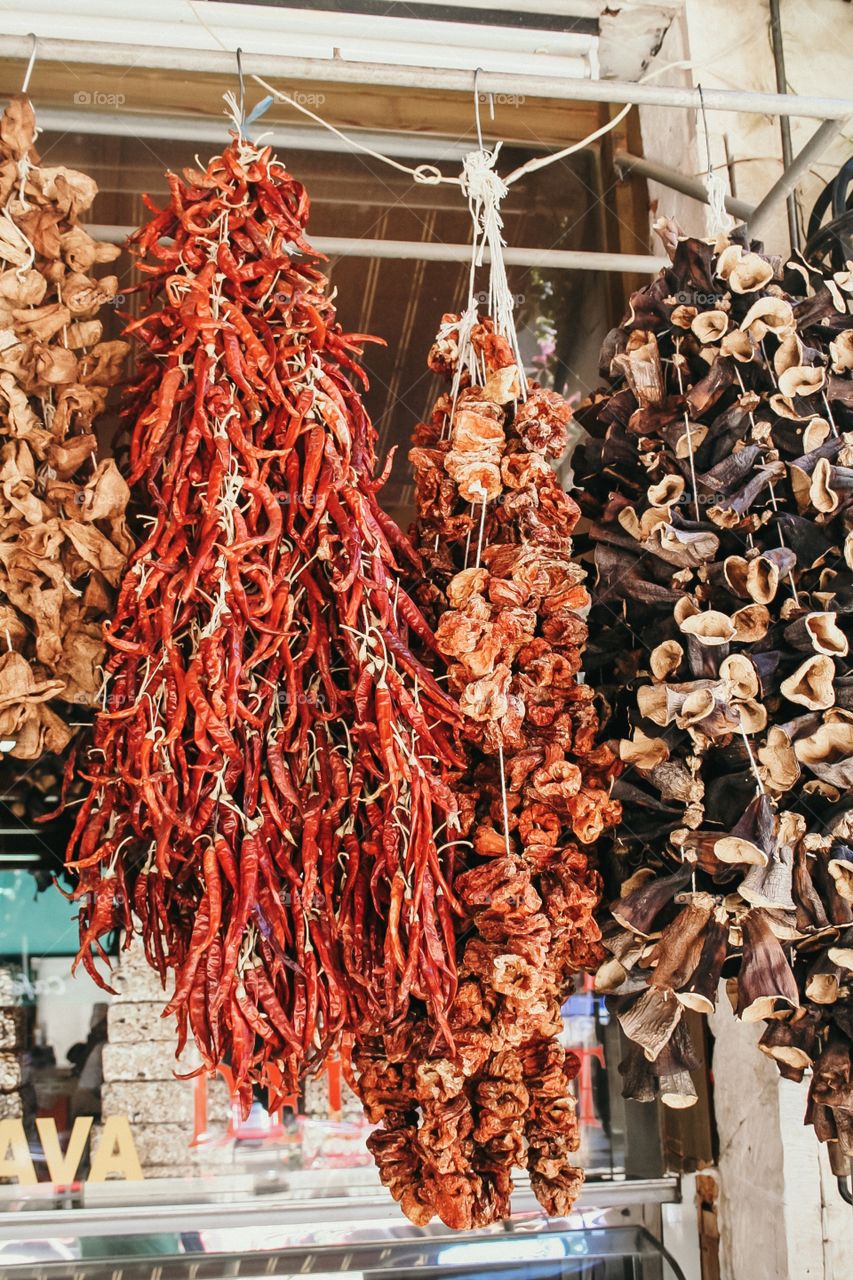 Dried chillies and mushrooms hanging at front of shop, Turkey