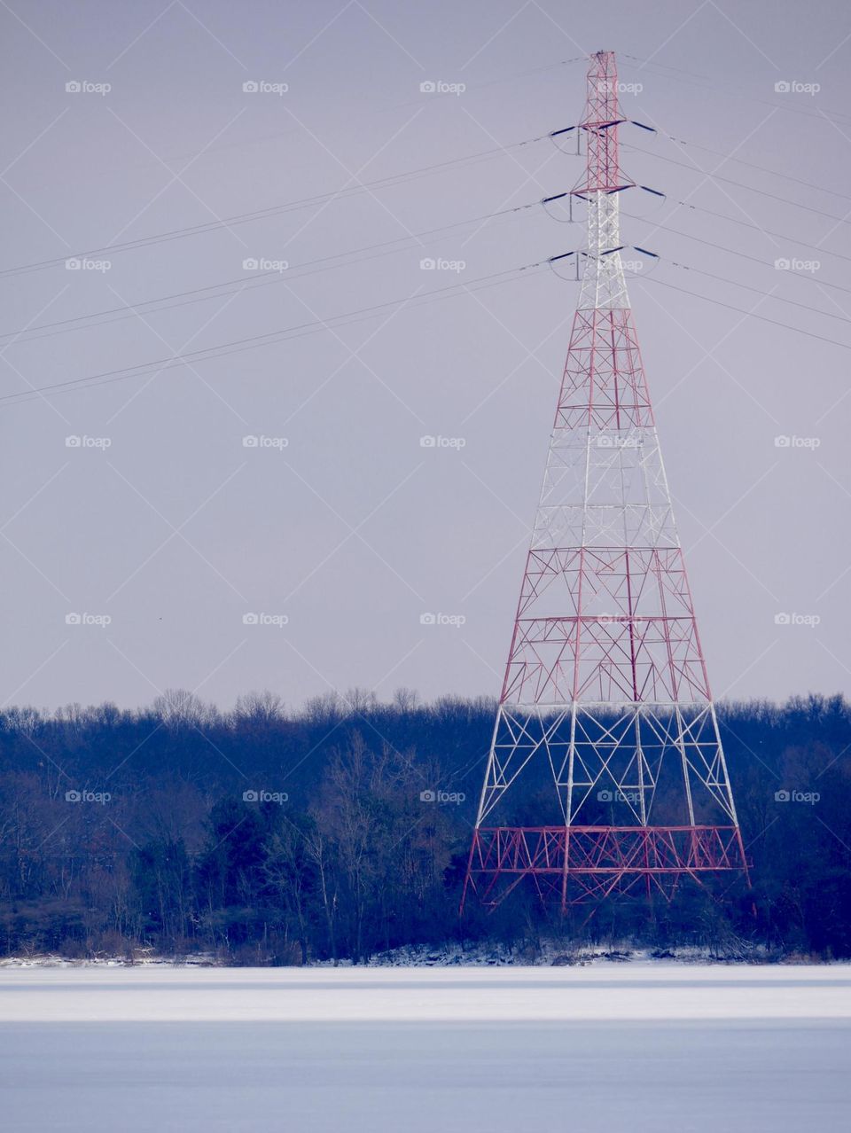 A red and white tower sits in the distance, on the other end of the reservoir. 