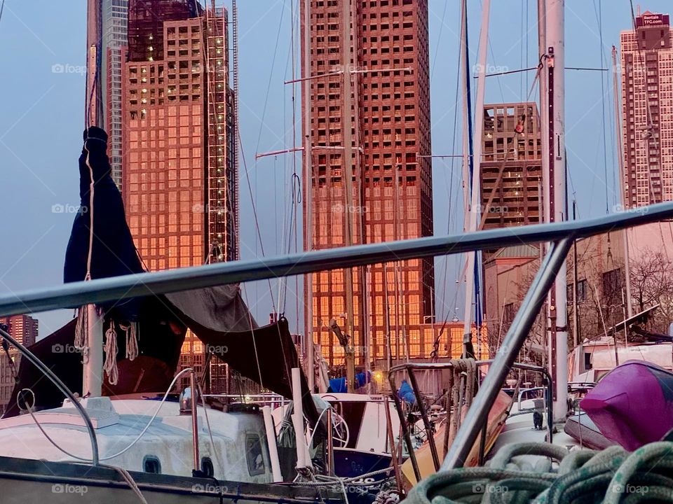 Golden hour is the time when the setting sun turns gold to orange, then red. The effect increases when high rises (under construction) have solid glass facades for the sun to reflect off such as  at “Newtown Creek”. 2023. Hypnotic Productions