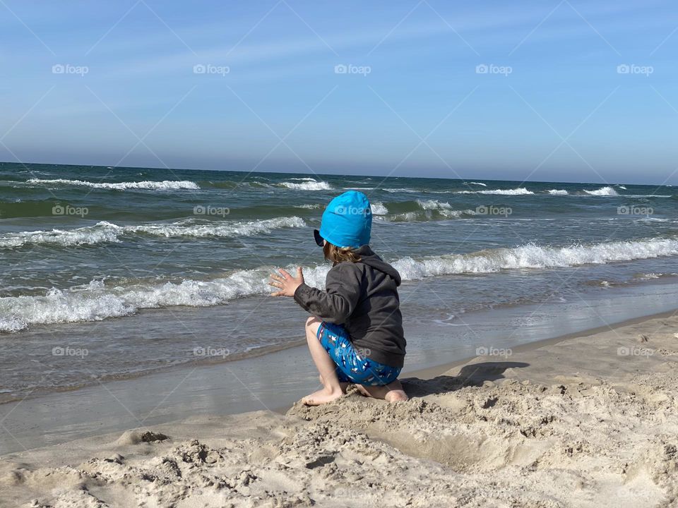 Boy playing on the beach 