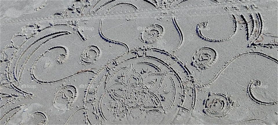 This artwork was drawn into wet sand on the beach of the island “Hiddensee” in the “Baltic Sea” or “Ostsee” in “Mecklenburg - Western Pomerania”, Germany. 2024. Hypnotic Productions