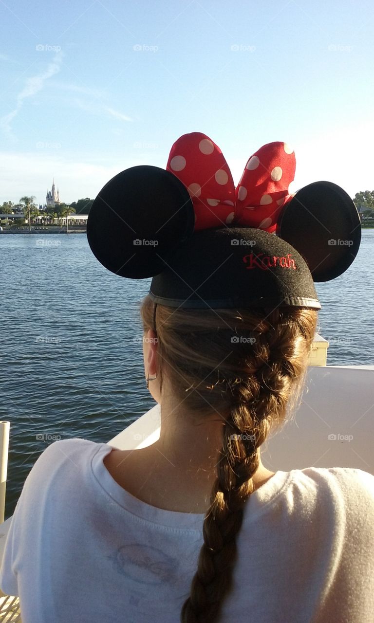 girl with mouse ears on approaching the magic kingdom via ferry boat