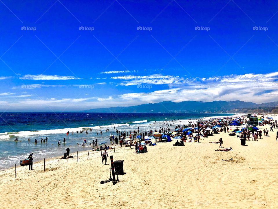 Santa Monica Beach in sunny California. Warm sand and blue waves make the perfect beach day in this vacation getaway