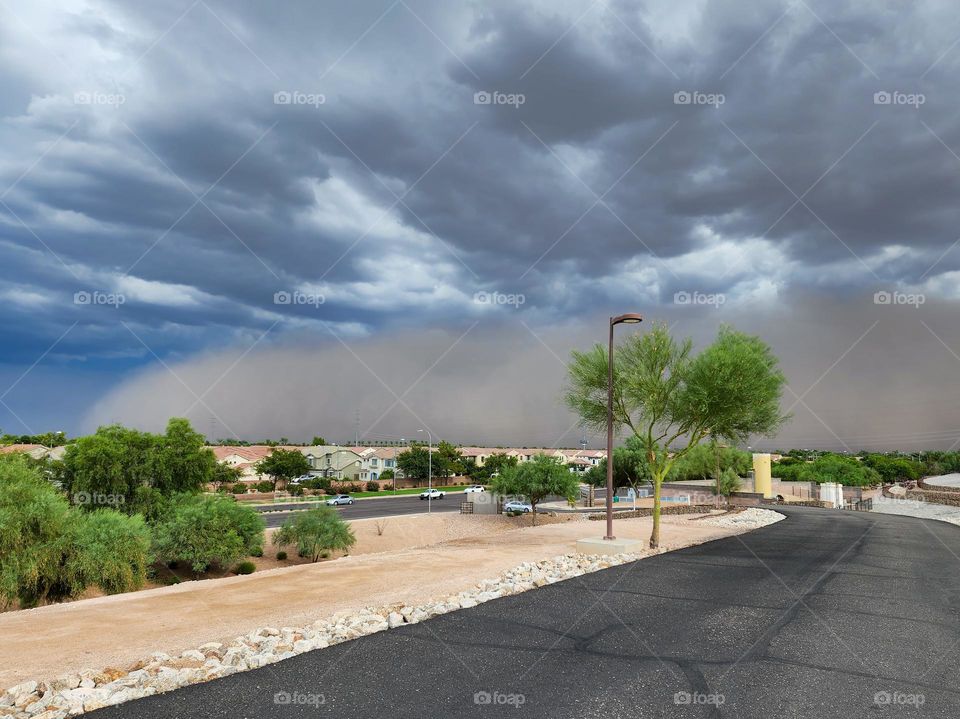 A massive haboob, or desert dust storm moves into Phoenix Arizona preceding a massive thunder cloud system.