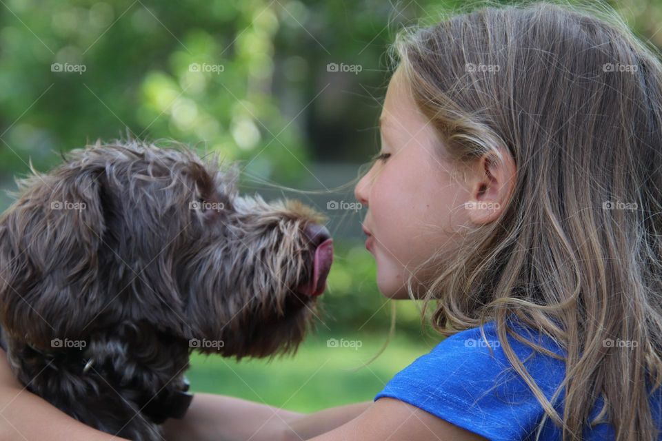 Girl going to kiss her dog 