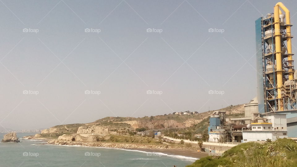 Walk of the beach, sea and factory