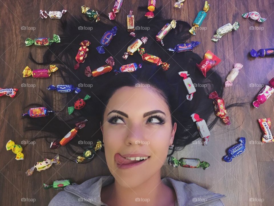 Young woman with various candy